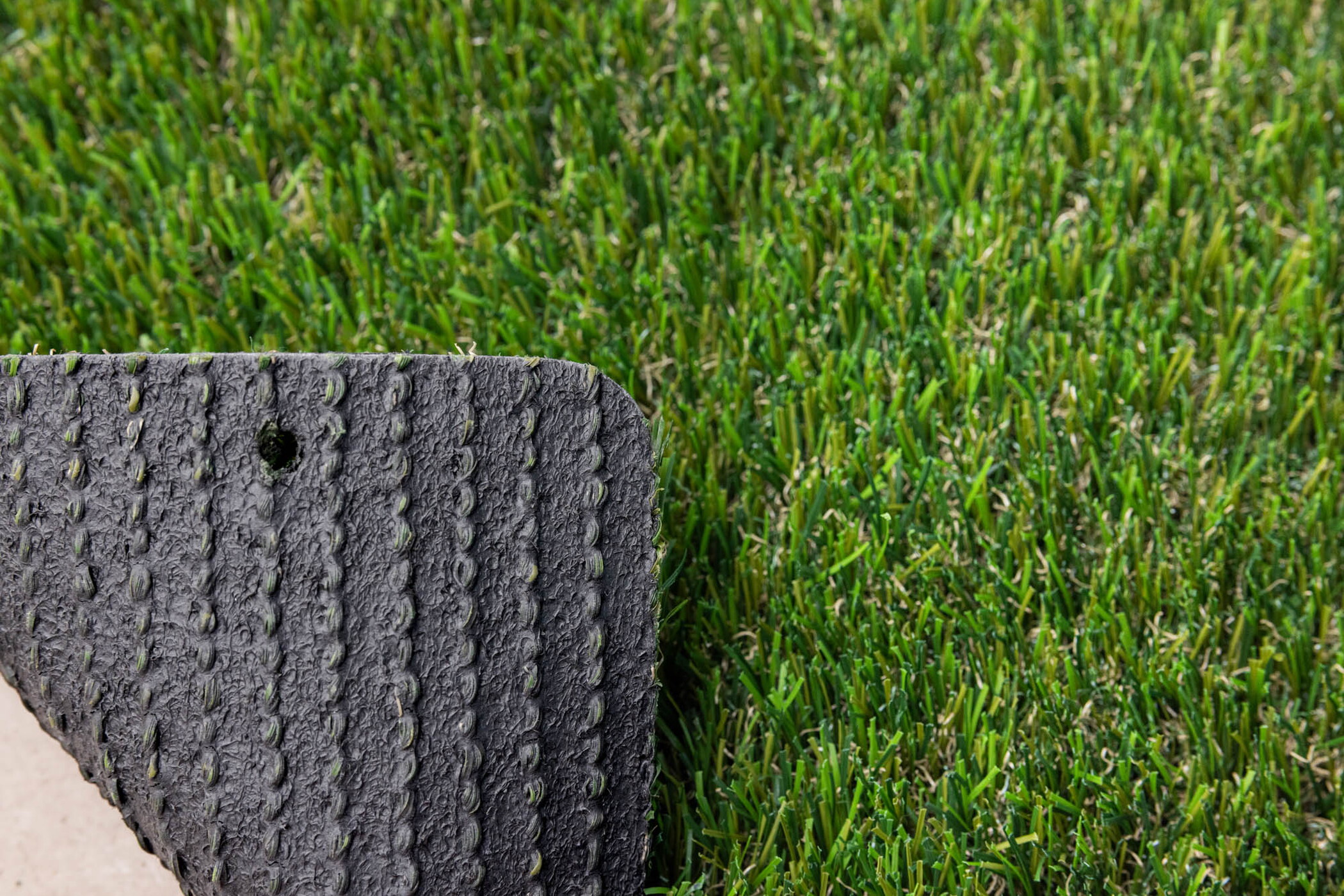 Durable latex backing for long-lasting artificial grass